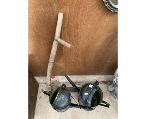 TWO VINTAGE METAL WATERING CANS AND A VINTAGE SYTHE 