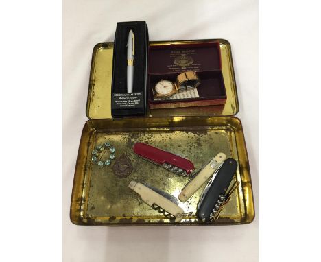 A VINTAGE TIN CONTAINING PEN KNIVES INCLUDING AN ORIGINAL SWISS ARMY KNIFE, WILKINSON SWORD, ETC PLUS A VINTAGE BOXED TIMEX W