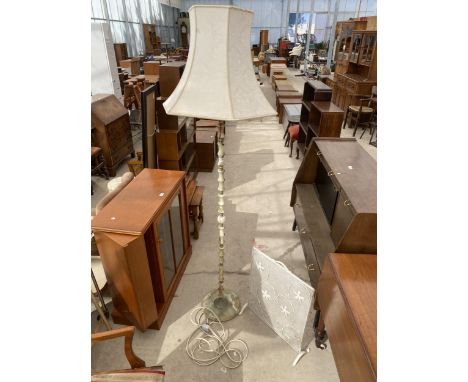 AN ONYX EFFECT STANDARD LAMP COMPLETE WITH SHADE AND WROUGHT IRON FIREGUARD 