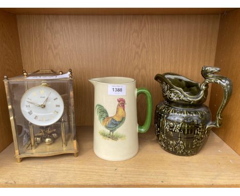 A BRASS ANIVERSARY CLOCK, A WOOD WARE JUG AND A FURTHER CERAMIC JUG 