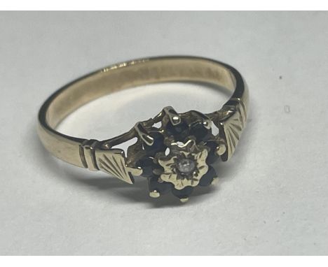 A 9 CARAT GOLD RING WITH A CENTRE DIAMOND AND SAPPHIRES IN A FLOWER DESIGN SIZE K 