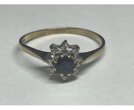 A 9 CARAT GOLD RING WITH A CENTRE SAPPHIRE AND SURROUNDING DIAMONDS SIZE Q/R 