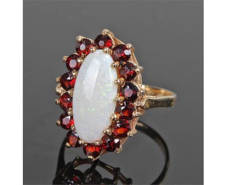 9 carat gold opal and garnet ring, the central opal with garnet surround, ring size O