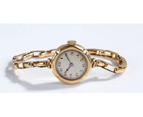 18 carat gold ladies wristwatch, the silvered dial with Arabic hours, manual wound, case 21mm diameter with an 18 carat gold 