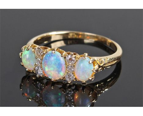 18 carat gold diamond and opal ring, set with three opals and six diamonds, ring size S