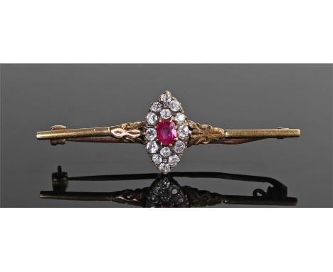 Yellow metal diamond and ruby brooch, the naiveté shaped head with central ruby and diamond surround, 50mm wide 