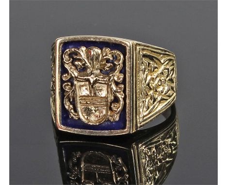 18 carat gold signet ring, with an heraldic crest above black enamel, foliate decoration on the shoulders, ring size S