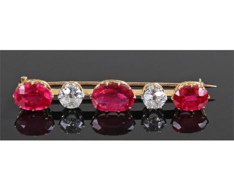 Ruby and diamond bar brooch, the central ruby at approximately 4 carats flanked by a pair of diamonds and a further pair of r