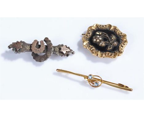 Victorian mourning brooch, with a black enamel and pearl flower brooch, together with a silver and gold horse shoe brooch and