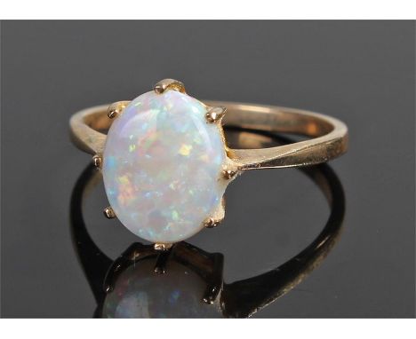 9 carat gold opal ring, the oval opal with eight claw mount, ring size P