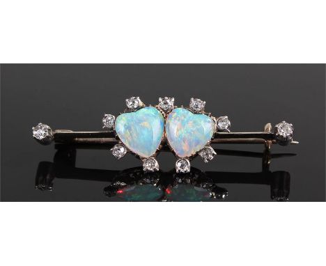 Opal and diamond set heart brooch, with a pair of heart carved opals and eleven diamonds to the surround and bar, 41mm long