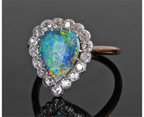 Diamond and opal ring, the pear cut opal with a round cut diamond surround, ring size S