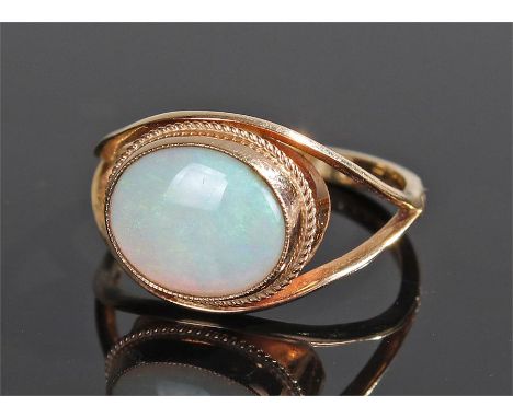 9 carat gold opal ring, the oval opal held within a bead head and tapering shank, ring size S