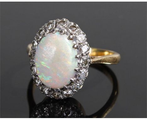 18 carat gold opal and diamond ring, with a central opal with diamond surround, ring size P