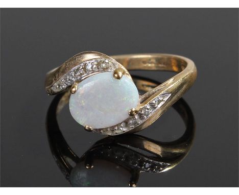 9 carat gold opal ring, the oval opal with swirl shoulders, ring size O