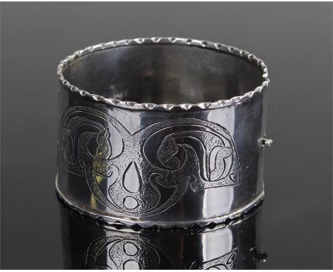 Silver Arts and Crafts bangle, Hallmarked Chester 1959, maker DT, with arched stylised decoration, 6cm wide