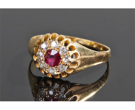 18 carat gold diamond and ruby ring, the central ruby with a diamond surround, ring size O