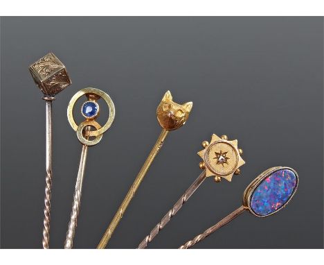 Collection of stick pins, to include a dice example, a sapphire set example, a star, a fox head and a fire opal example, (5)