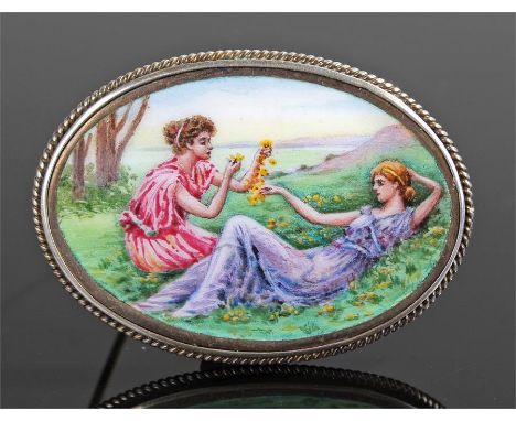 Early 20th Century enamel and silver brooch, the enamel brooch depicting a reclining lady and a relaxed lady eating grapes, w