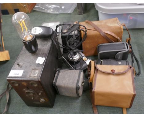 Collection of vintage cameras one converted to a lamp