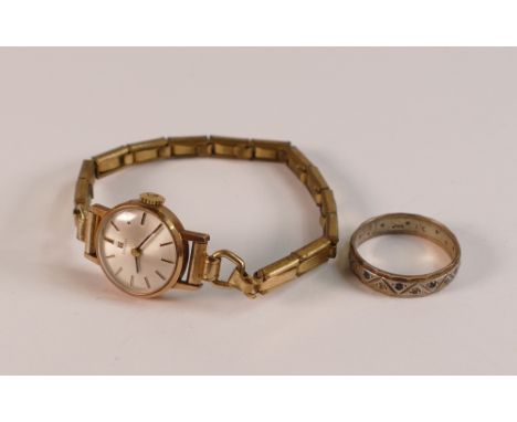 9ct gold ladies Tissot watch with gold plated strap and 9ct gold and silver eternity ring, 2.2g.