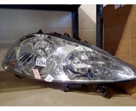 Peugeot headlamp unit, TGH7GTG. Not available for in-house P&amp;P