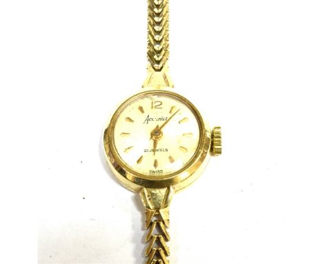 ACCURIST, A LADY'S 9CT GOLD ROUND BRACELET WATCH, CIRCA 1960 the silvered dial with raised gilt 12 and baton numerals and han