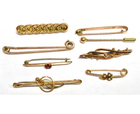 SEVEN EARLY 20TH CENTURY GOLD BROOCHES AND A STICK PIN The brooches in varied designs including a reeded curb-link example, s