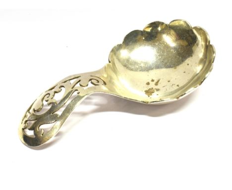 A MODERN SILVER CADDY SPOON with a foliate pierced handle and a petal-shaped bowl, mark of Oliver &amp; Bower Ltd, Sheffield 