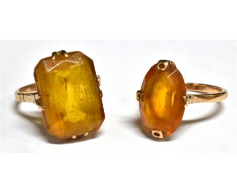 TWO VINTAGE GOLD AND ORANGE-PASTE SINGLE STONE RINGS comprising; one with a canted-rectangular stone claw set on a 'D' sectio