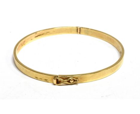 A VINTAGE 9CT GOLD FLAT-SECTION HINGED BANGLE the plain push-snap with a figure-of-eight safety clasp, London 1979, approx. 5