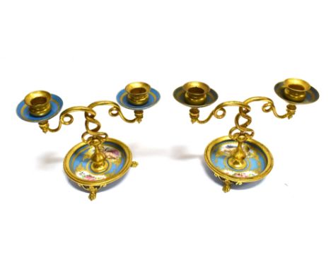 A PAIR OF FRENCH SEVRES STYLE ORMOLU MOUNTED TWIN BRANCHED CANDLESTICKS  the ceramic circular base and sconces painted with p