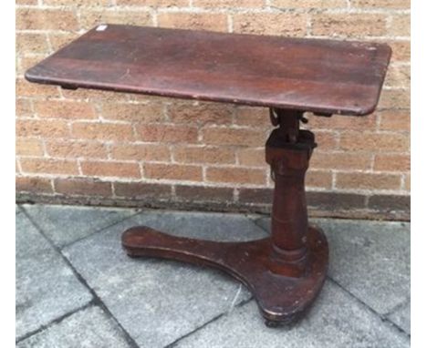 A VICTORIAN INVALIDS TABLE  the tilting top 42cm x 84cm, on pillar support with ratchet rise and fall mechanism