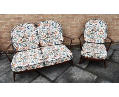 AN ERCOL FLEUR DE LYS PATTERN TWO SEATER SOFA AND MATCHING ARMCHAIR  with removable loose cushions