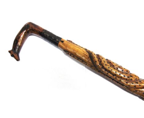A CARVED WALKING STICK  possibly prisoner-of-war work, the shaft entwined with four snakes, the grip with a dog's head termin