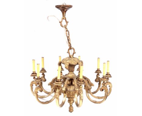 A 20TH CENTURY TEN BRANCH CAST BRASS CANDELABRA with floral decoration and bunches of grapes, shaped branches with faux candl