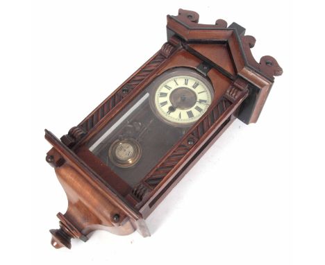 A LATE 19th CENTURY VIENNA STYLE WALL CLOCK with architectural walnut case enclosing a 4.5” porcelain dial fronting a spring 