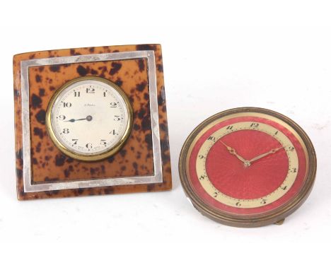 TWO TRAVEL STRUT CLOCKS ONE WITH PINK ENAMEL DIAL 7.6cm diameter, the other faux tortoise shell 9cm high.