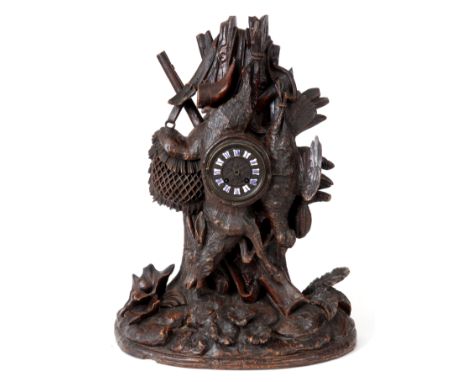 A LATE 19th CENTURY CARVED SWISS BLACK FOREST MANTLE CLOCK sculptured as a hanging partridge and deer with rifle, powder flas