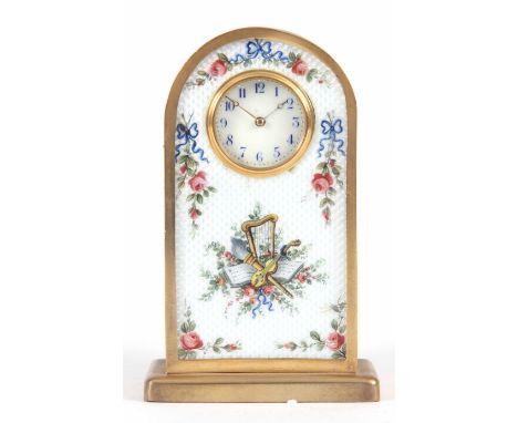 AN ENAMEL AND GILT MINIATURE MANTEL CLOCK with porcelain dial decorated with musical instruments &amp; flowers 10cm