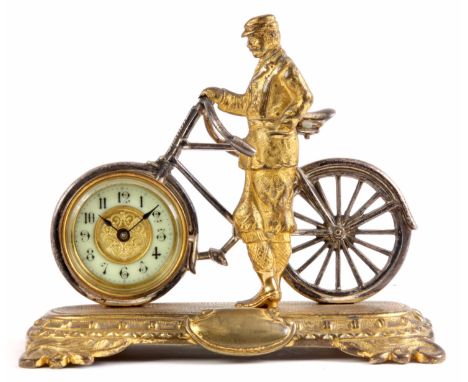 A LATE 19th CENTURY ENGLISH NOVELTY DESK CLOCK formed as a well dressed gentleman stood next to a bicycle on rounded rectangu
