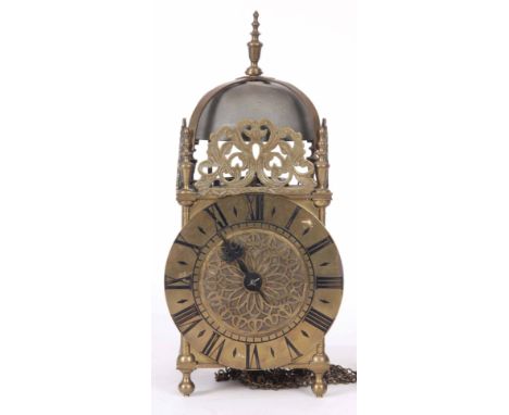 A LATE 19th CENTURY BRASS CASED LANTERN CLOCK of typical form with a large bell above a 6.5" brass dial fronting a weight dri