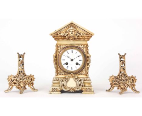 A LATE 19th CENTURY FRENCH CREAM PAINTED BRASS CASED CLOCK GARNITURE with architectural case enclosing a 3" porcelain dial fr