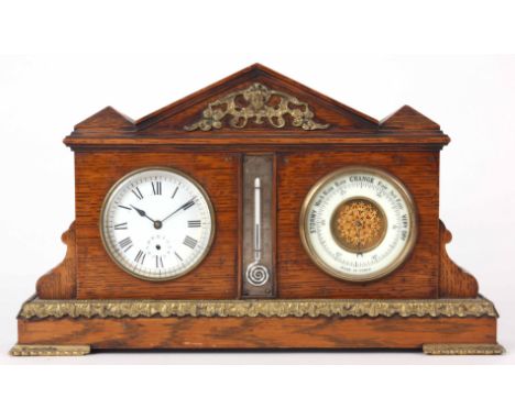 A LATE 19th CENTURY OAK CASED WEATHER STATION the architectural style case with gilt brass mounts enclosing a clock barometer