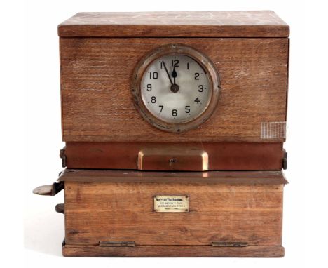 AN EARLY 20th CENTURY OAK CASED TIME RECORDER/ CLOCKING IN MACHINE with painted Arabic dial fronting a large spring driven mo