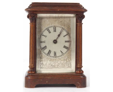 AN EARLY MAHOGANY CASED CARRIAGE STYLE MANTLE CLOCK with glass panels and Corinthian column corners enclosing a 2.5" silvered