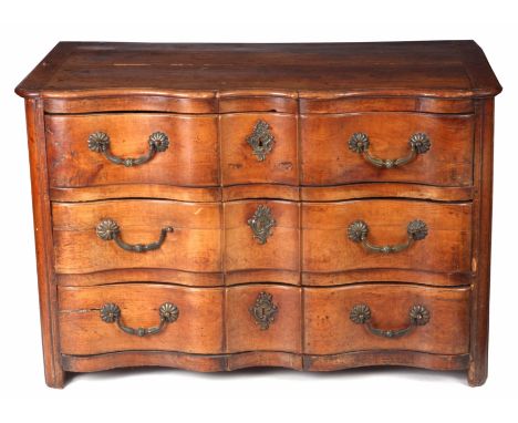 AN 18TH CENTURY FRENCH FRUITWOOD SERPENTINE COMMODE of generous size and of joined construction having three graduated drawer
