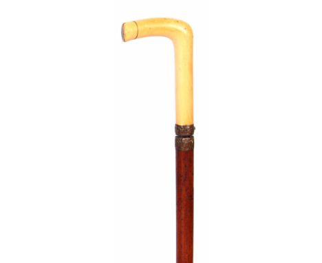 AN EARLY 19TH CENTURY MALACCA IVORY HANDLE SWORD STICK with embossed brass rococo band having a release button, revealing a t
