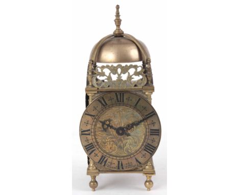 AN EARLY 20th CENTURY BRASS LANTERN STYLE MANTLE CLOCK of typical form with engraved dial and 4" Roman chapter ring fronting 