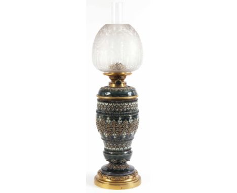 A 19th CENTURY ROYAL DOULTON OIL LAMP having relief mounted stylised decoration with polychrome colours 69cm high.ConditionIn